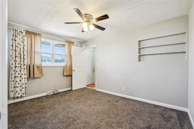 unfurnished bedroom featuring dark carpet and ceiling fan