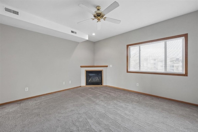 unfurnished living room with carpet floors and ceiling fan