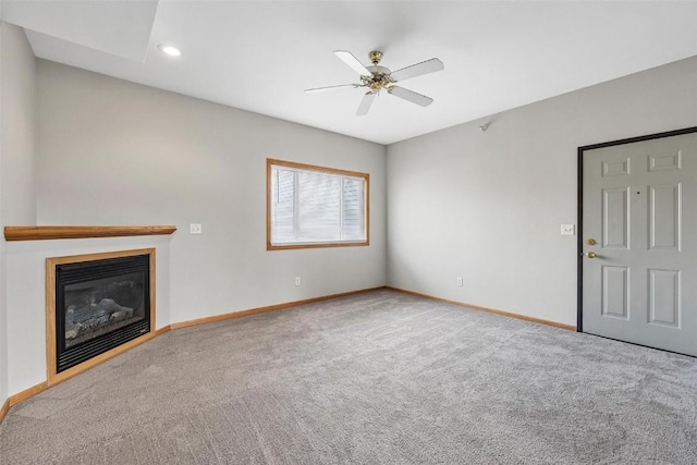 unfurnished living room featuring ceiling fan and carpet