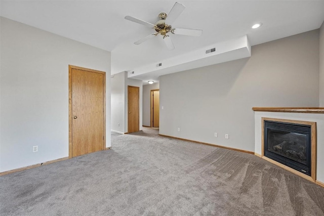 unfurnished living room featuring ceiling fan and light colored carpet