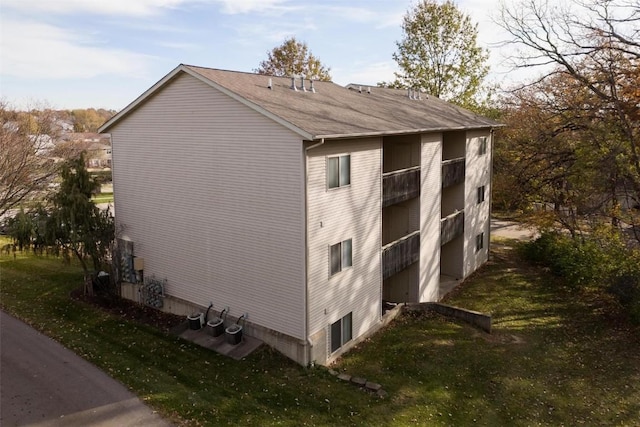 view of side of home with a yard