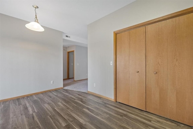 interior space featuring a closet and dark wood-type flooring