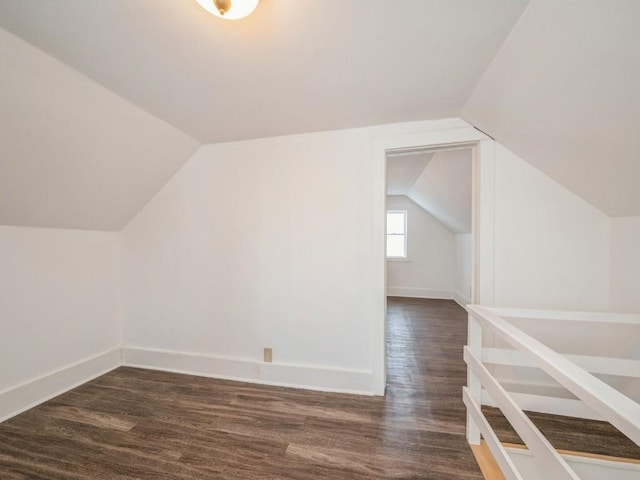 additional living space with dark hardwood / wood-style flooring and lofted ceiling