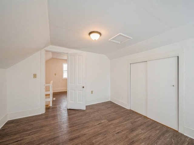 bonus room with vaulted ceiling and dark wood-type flooring