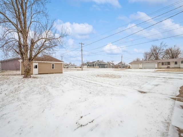 yard covered in snow featuring a garage