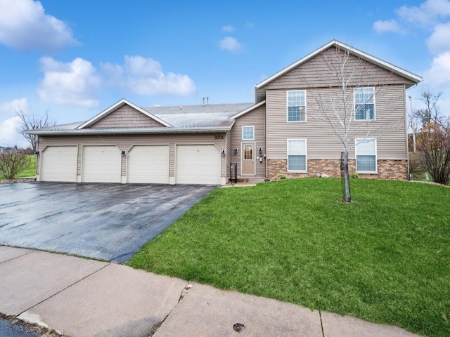 view of front of property featuring a garage and a front lawn