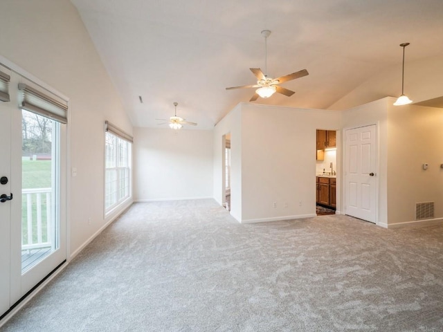 spare room featuring carpet floors, sink, ceiling fan, and vaulted ceiling