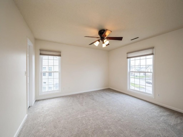 carpeted empty room with ceiling fan