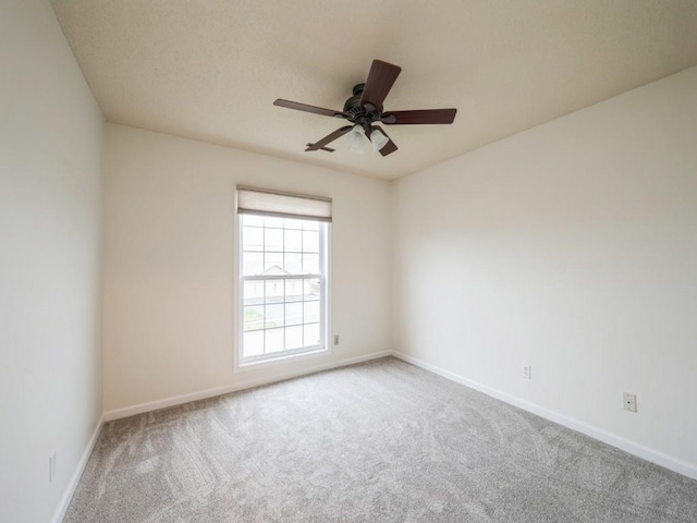 empty room featuring carpet flooring and ceiling fan