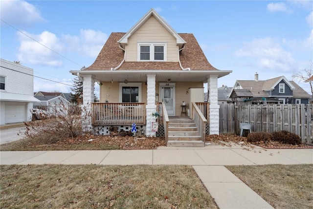 bungalow-style home featuring a front yard and covered porch