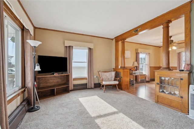 living room with crown molding, carpet floors, decorative columns, and baseboard heating