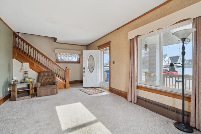 entryway featuring radiator heating unit, ornamental molding, and light colored carpet