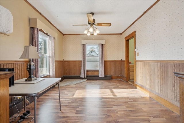 interior space with crown molding, a wealth of natural light, and wood-type flooring