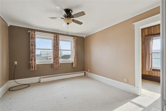 unfurnished room featuring light carpet, a baseboard heating unit, and ornamental molding