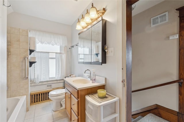 full bathroom featuring tile patterned flooring, vanity, tiled shower / bath combo, and toilet