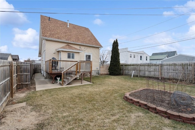 rear view of house featuring a yard, a deck, and a patio area