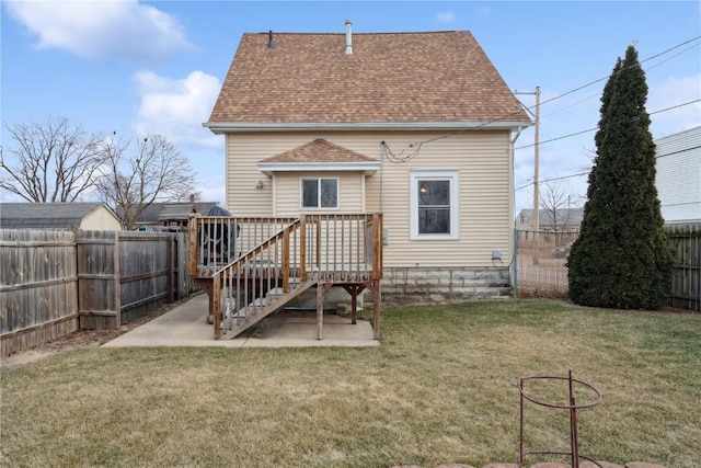 rear view of property featuring a patio, a wooden deck, and a lawn