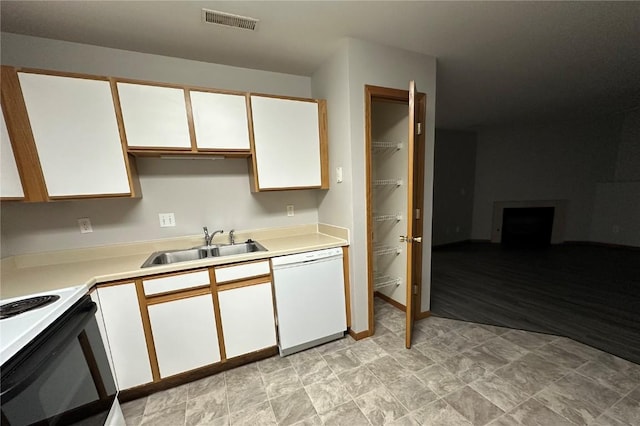 kitchen featuring white cabinetry, sink, and white appliances