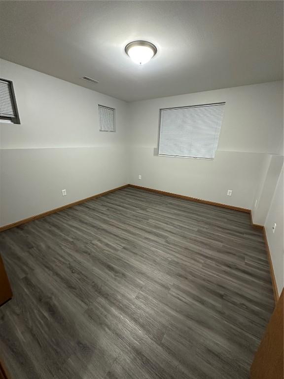 unfurnished room featuring dark wood-type flooring