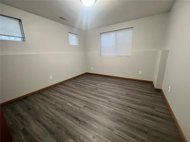 empty room with dark hardwood / wood-style floors