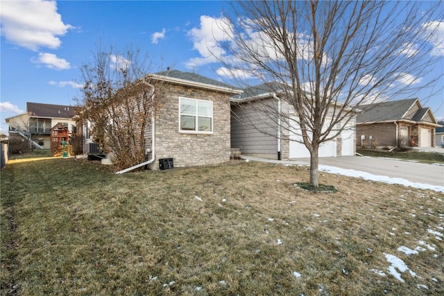 view of front of property featuring a garage, a front yard, and a playground