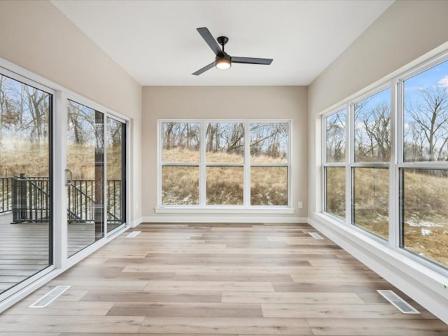 unfurnished sunroom with plenty of natural light and ceiling fan