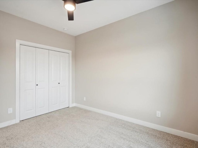 unfurnished bedroom featuring ceiling fan, carpet floors, and a closet