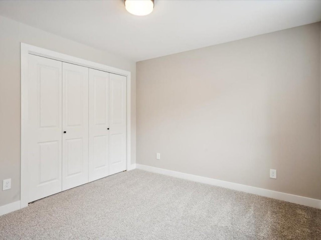 unfurnished bedroom featuring a closet and carpet flooring