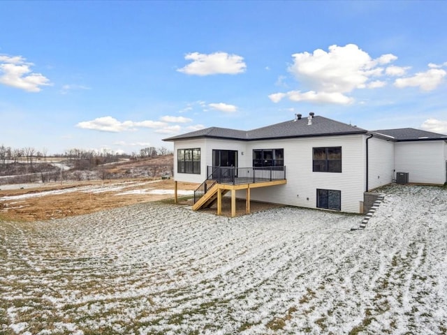 snow covered property featuring a deck