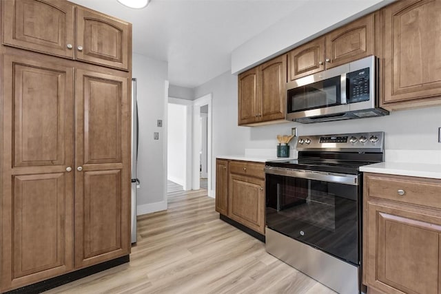 kitchen featuring stainless steel appliances and light wood-type flooring