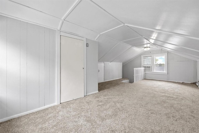 bonus room featuring lofted ceiling and carpet flooring