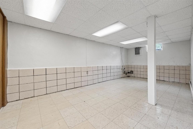 basement featuring a drop ceiling