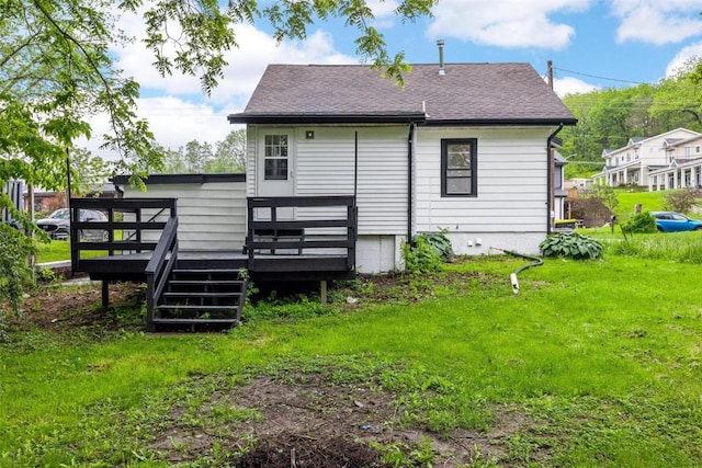 back of house featuring a yard and a deck