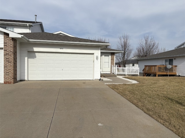 view of side of home with a wooden deck, a garage, and a yard