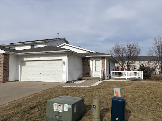 view of front of home featuring a garage and a front lawn