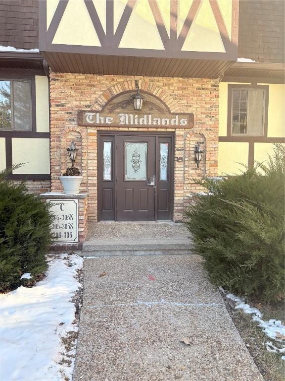 view of snow covered property entrance