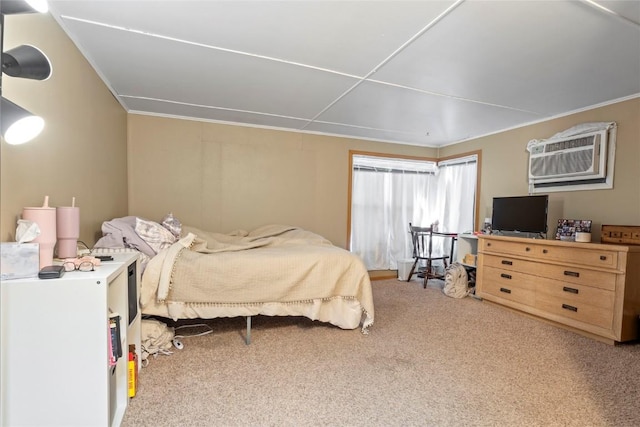 bedroom with an AC wall unit and carpet flooring