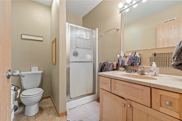 bathroom with tile patterned flooring, vanity, toilet, and a shower with shower door