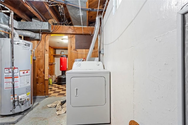 clothes washing area with gas water heater and washer / dryer