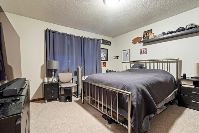 bedroom with carpet flooring and a textured ceiling