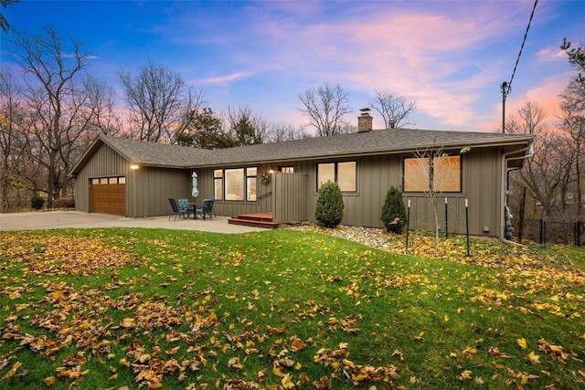 view of front of property featuring a yard and a garage