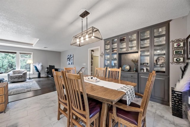 dining space with a textured ceiling