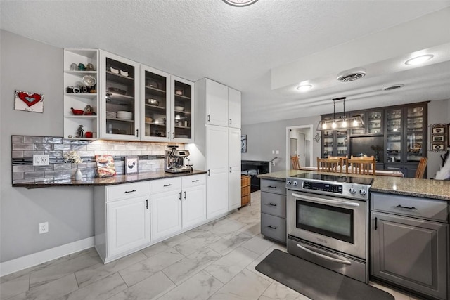 kitchen featuring white cabinetry, decorative light fixtures, dark stone counters, and stainless steel electric range oven