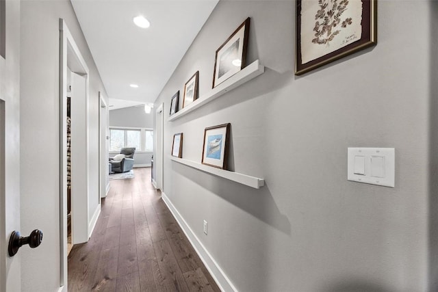 corridor featuring lofted ceiling and dark hardwood / wood-style floors