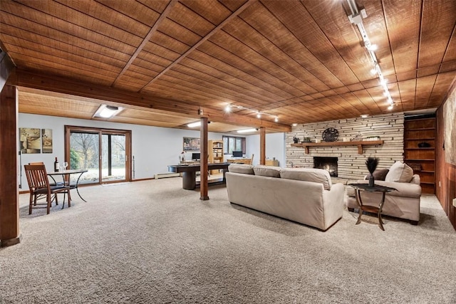 carpeted living room with wood ceiling, track lighting, and a stone fireplace