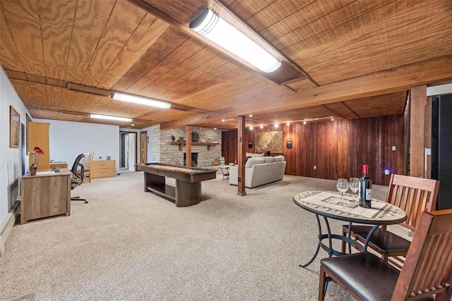 living room featuring light colored carpet, a fireplace, wood ceiling, and wood walls