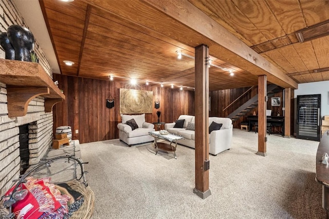 carpeted living room featuring wooden ceiling and wood walls