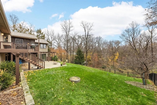 view of yard with a wooden deck and a patio area