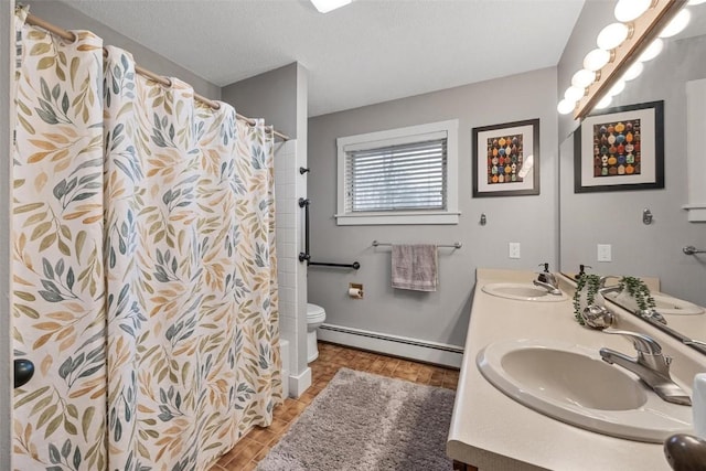 bathroom with walk in shower, toilet, a textured ceiling, baseboard heating, and vanity