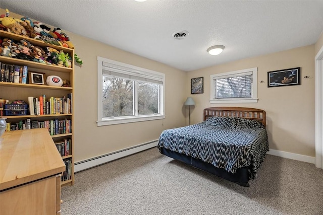 bedroom featuring multiple windows, carpet flooring, a textured ceiling, and baseboard heating